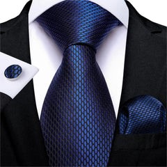 A navy blue silk necktie set featuring a textured honeycomb pattern with a matching pocket square.