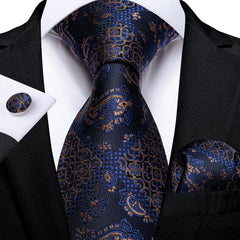 A navy blue silk necktie set featuring a gold floral pattern with matching pocket square and cufflinks.
