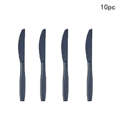A set of four black disposable plastic knives arranged vertically against a white background.