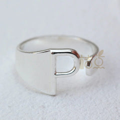 A silver-plated open ring featuring a prominent letter P design.
