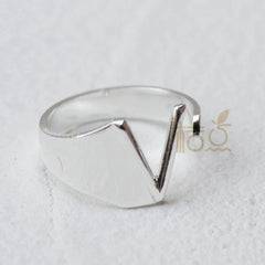 A silver-plated open ring featuring a prominent V-shaped letter design.