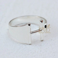 A silver-plated open ring featuring a stylized letter H design on a plain white background.