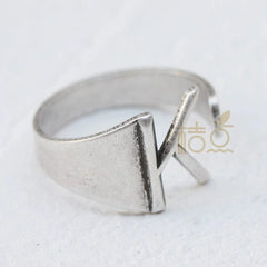 A silver-plated open ring featuring a prominent letter K design.