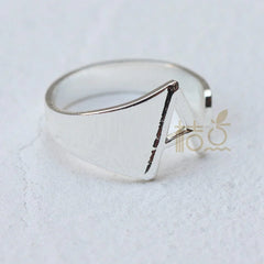 A silver-plated open ring featuring a prominent letter A design on a textured white background.