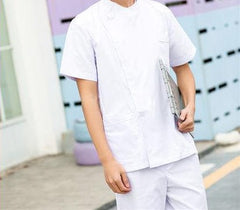 A person wearing a white short-sleeved medical scrub top and matching pants.