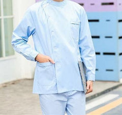 A person wearing a light blue unisex medical scrub set with a side-buttoned top and pockets.