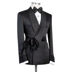 A black double-breasted suit jacket with a shawl lapel and a matching waist tie on a mannequin.