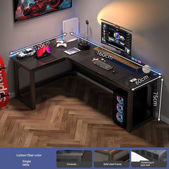 An L-shaped computer desk with a carbon fiber finish and a black steel frame.