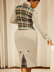 A woman wears a beige long-sleeved dress with a plaid vest and a matching plaid-lined back vent.