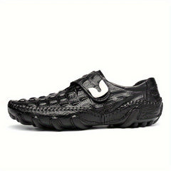 Black leather loafers with a crocodile texture, a hook and loop strap, and a rubber sole.