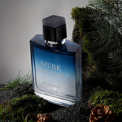 A bottle of Azure Coastal eau de parfum sits on a bed of moss and pine needles.