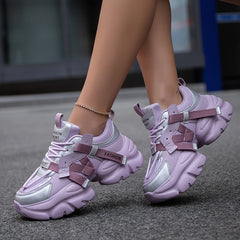 Women's trendy lavender and silver chunky sneakers with lace-up closures and strap details.