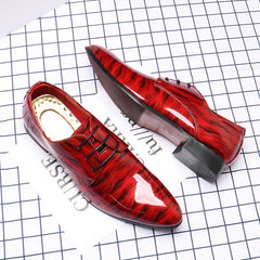 A pair of glossy red ripple-patterned men's lace-up dress shoes with pointed toes.
