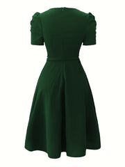 A solid dark green A-line dress with short puff sleeves and a back zipper closure.
