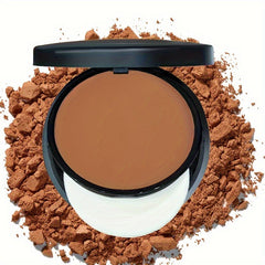 A compact of matte powder makeup in a warm brown shade sits atop a pile of loose powder.