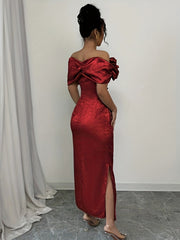 A woman wears a red off-shoulder bodycon maxi dress with a side slit and textured fabric.