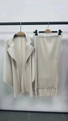 A beige pleated two-piece set featuring a batwing sleeve jacket and a tassel-hem A-line skirt.