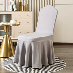 A light gray, one-piece elastic chair cover with a pleated skirt design.