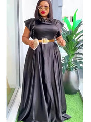 A woman wears a black satin floor-length gown with a high neckline, cap sleeves, and a gold belt.