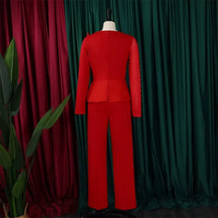 A red long-sleeved jumpsuit with beaded detailing on one sleeve and a high-waisted peplum design.