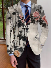 A man wears a long-sleeve blazer featuring an all-over floral print in a traditional ink-wash style.