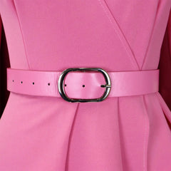 A close-up of a pink pleated dress featuring a matching pink belt with a silver oval buckle.