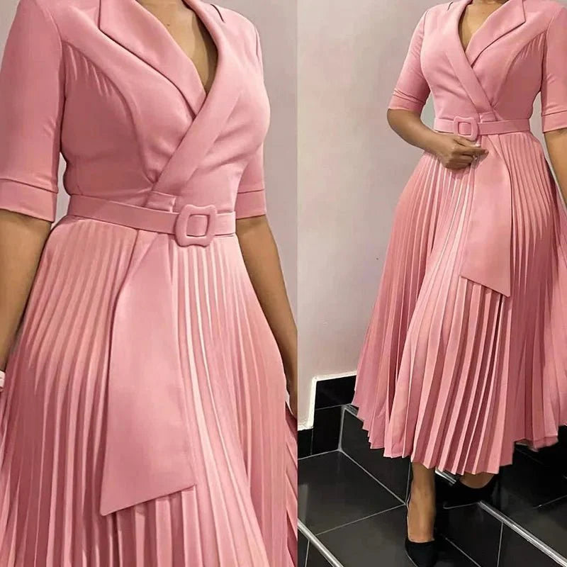 A pink midi dress with a notched collar, half sleeves, and a pleated skirt with a matching belt.