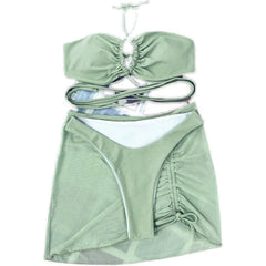 A sage green three-piece bikini set featuring a ruched top, high-cut bottoms, and a matching skirt.