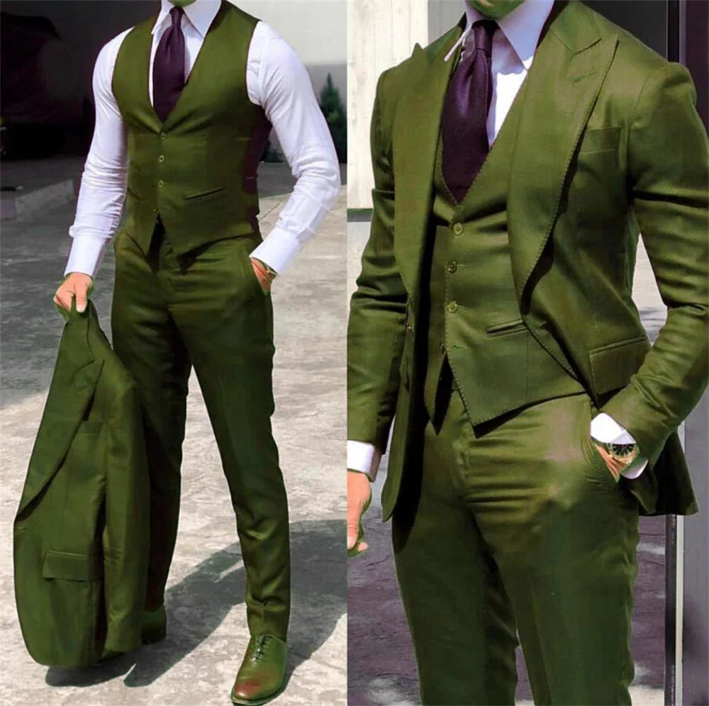 A man wears a slim-fit olive green three-piece suit with a white shirt and dark tie.
