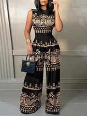 A woman wears a sleeveless black wide-leg jumpsuit featuring a tan geometric and floral print.