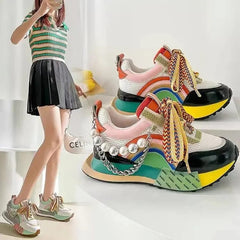Multi-colored platform sneakers featuring a pearl chain accent and patterned laces.
