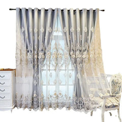 Luxury grey curtains featuring intricate floral embroidery and a sheer lace overlay.