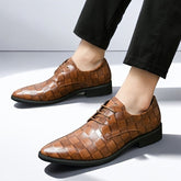 Men's brown faux leather oxford dress shoes with a checkered pattern and black soles.