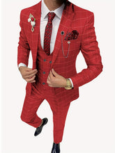 A man wears a slim-fit red plaid three-piece suit with a white shirt and patterned tie.