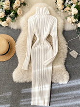 A white long-sleeve turtleneck sweater dress with a ribbed knit texture.