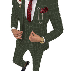 A man wears a slim-fit olive green plaid three-piece suit with a red patterned tie and pocket square.