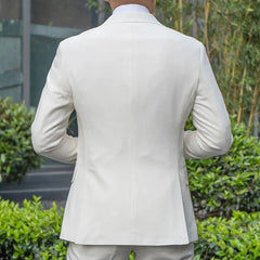 A man wearing a white two-button single-breasted suit jacket with a double-vented back.