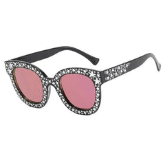 Black cat-eye sunglasses with pink gradient lenses and silver star embellishments on the frame.