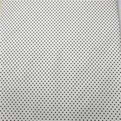 White fabric featuring a repeating pattern of small black polka dots.