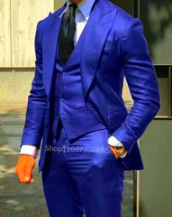 A man wears a vibrant blue three-piece suit consisting of a blazer, vest, and trousers.