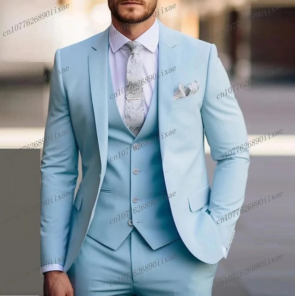 A man wears a light blue three-piece suit consisting of a blazer, vest, and trousers.
