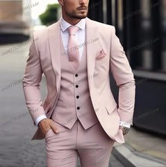 A man wears a formal three-piece light orange suit with a matching vest, tie, and pocket square.