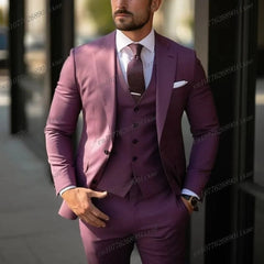 A man wears a formal three-piece purple suit consisting of a blazer, vest, and matching trousers.