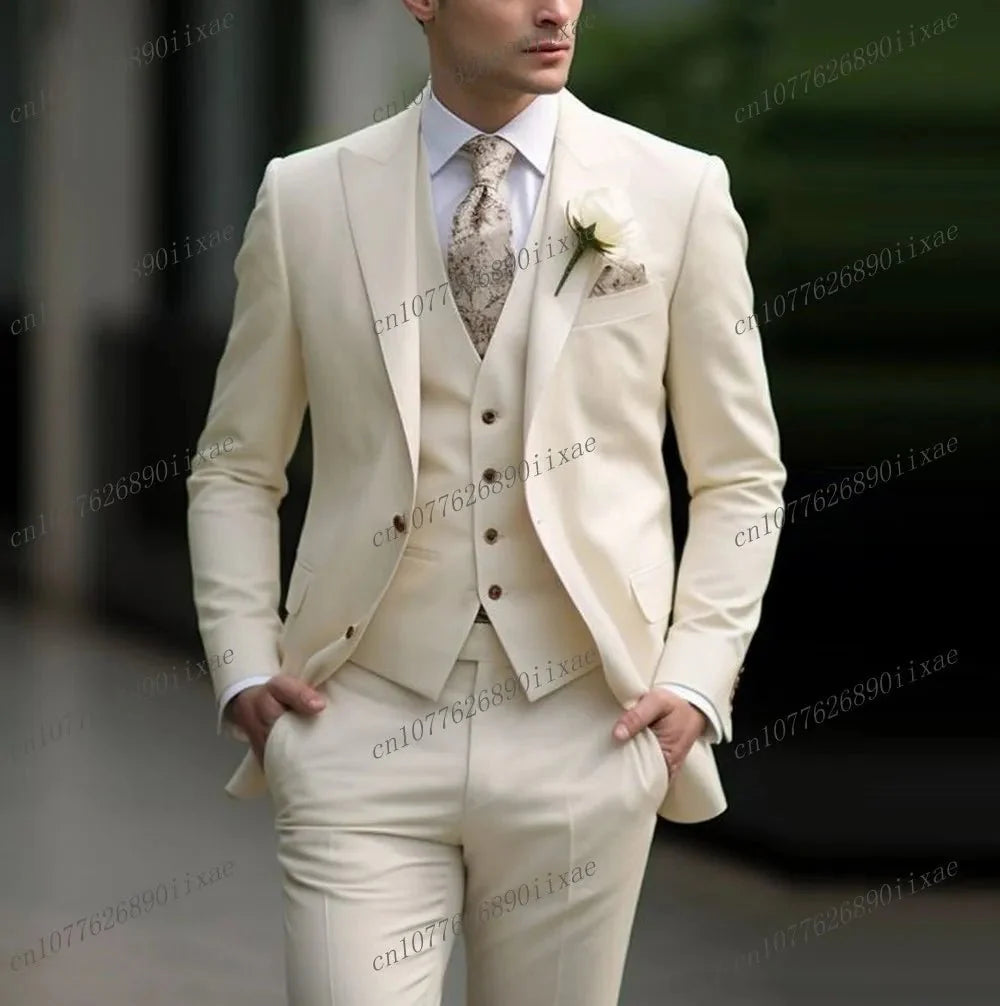 A man wears a formal three-piece cream suit consisting of a blazer, vest, and trousers.