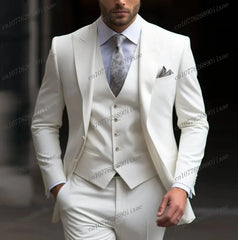 A man wears a formal white three-piece suit consisting of a blazer, vest, and trousers.