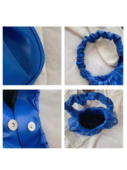 A bright blue pleated hobo bag with a gathered handle and magnetic snap closure.