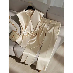 A champagne satin two-piece set featuring a sleeveless bow-waist vest and wide-leg trousers.