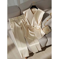 A champagne satin two-piece set featuring a sleeveless bow-waist vest and wide-leg trousers.