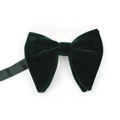 A large, dark green velvet bow tie with a solid pattern on a white background.