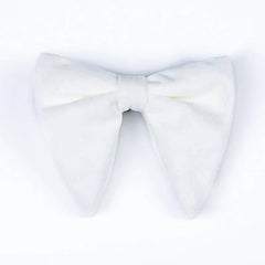 A large, solid white velvet bow tie with a classic pointed shape on a plain background.